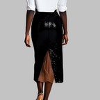 Black sequin skirt with a white top on a gray background