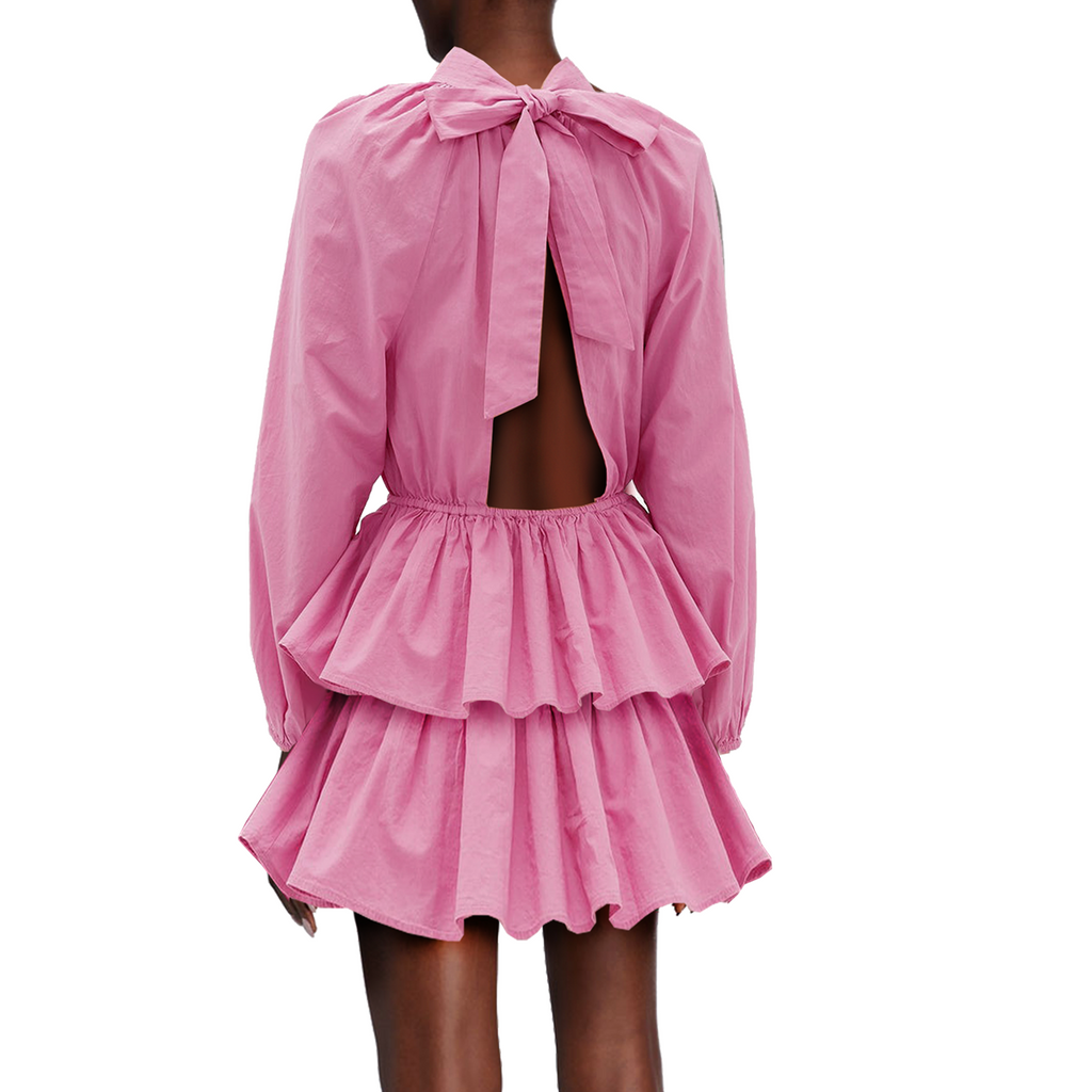 Pink dress with long sleeves and cut-out back on a white background