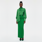 Woman wearing a green outfit on a white background