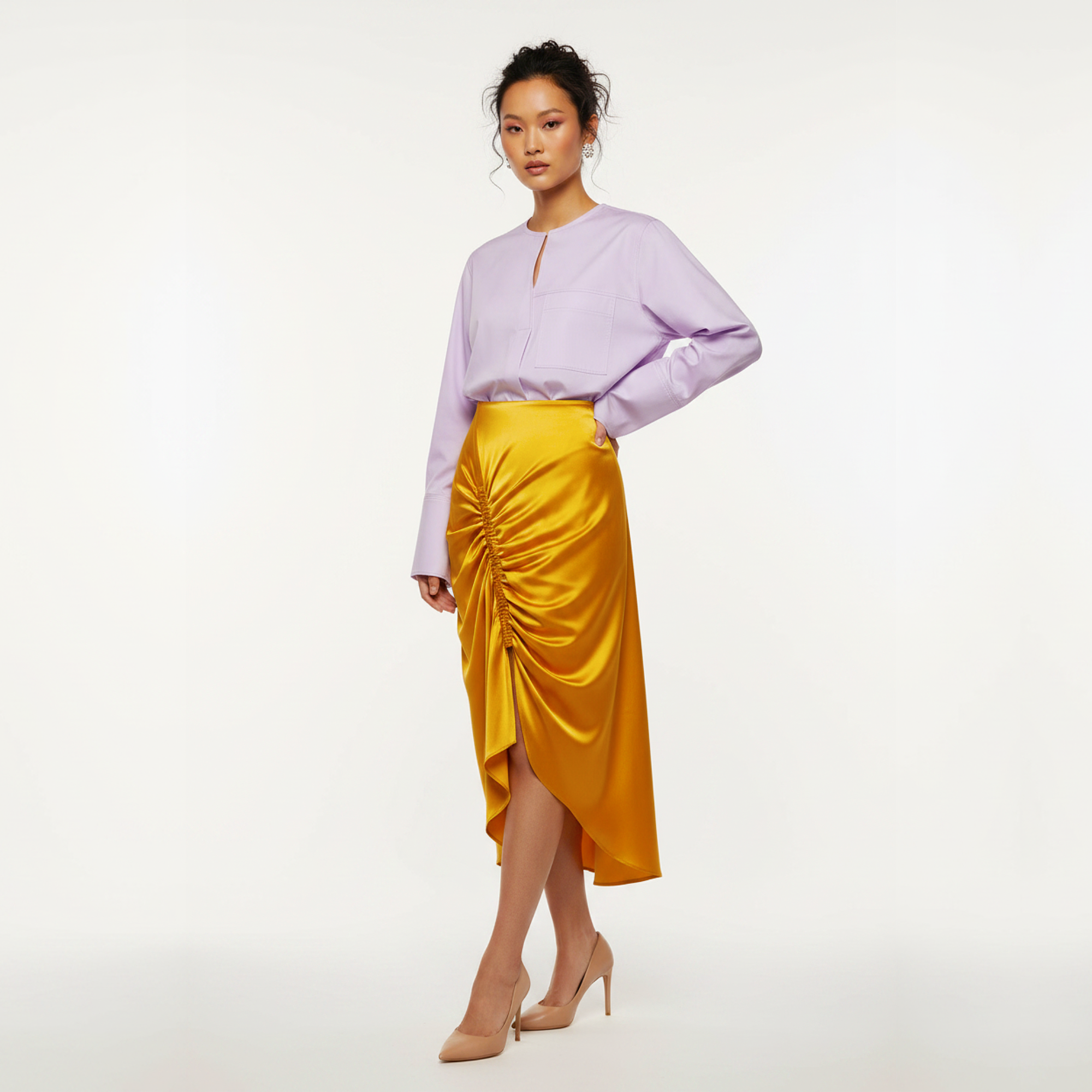 Woman wearing a purple blouse and yellow skirt on a white background