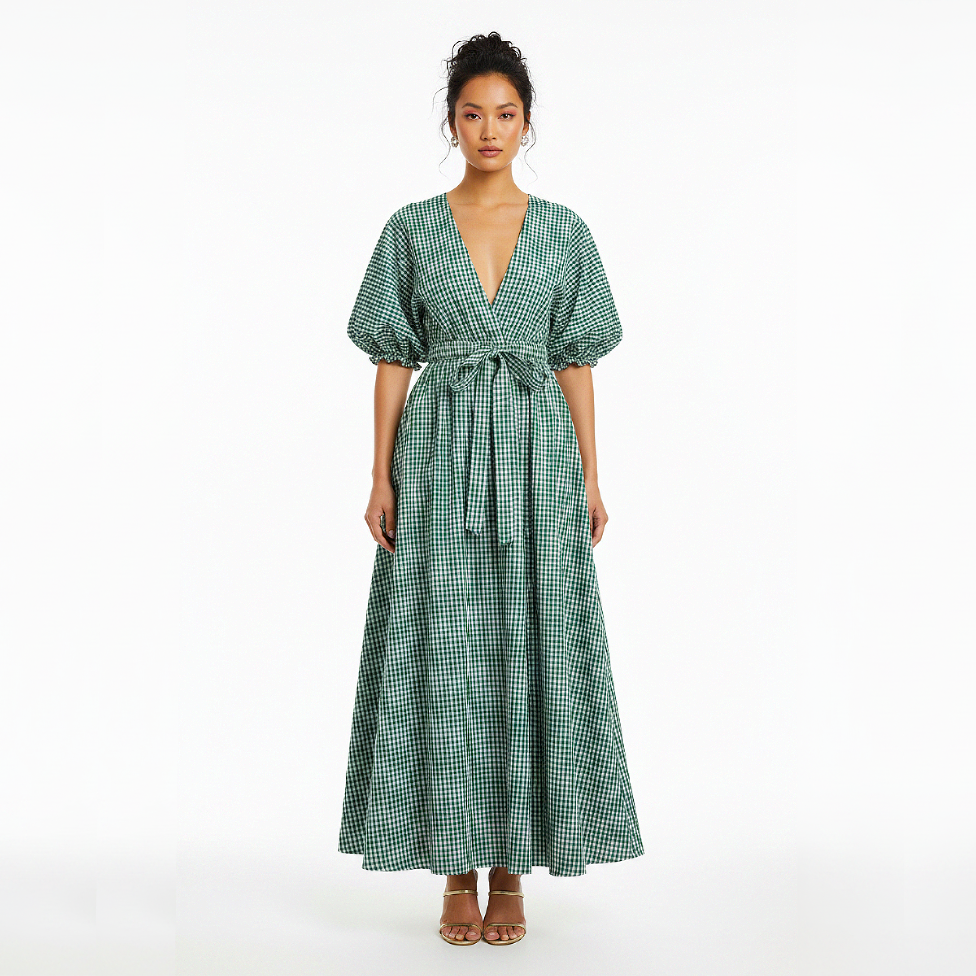 Woman wearing a green checkered dress on a white background