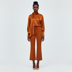 Woman wearing an orange outfit on a white background