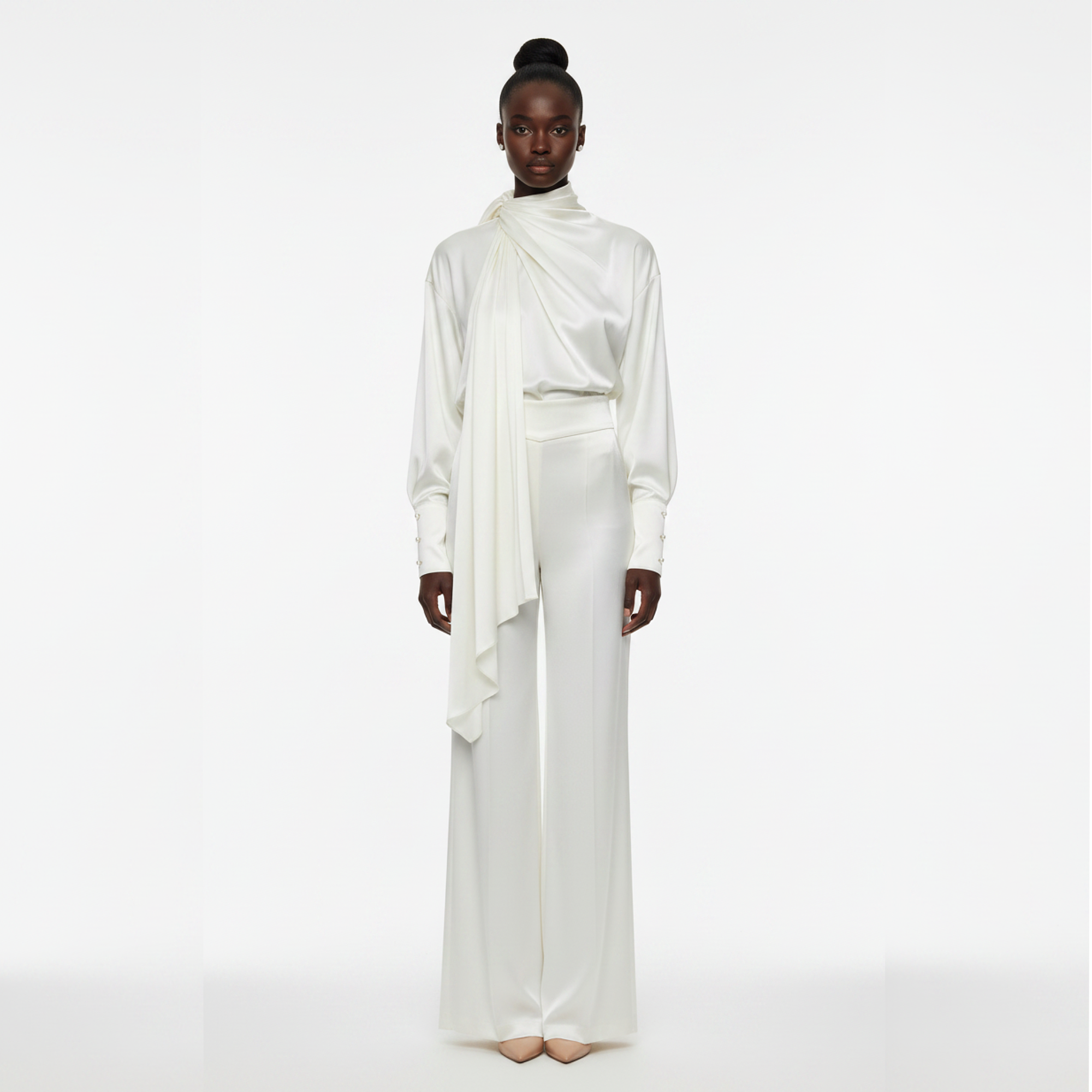 Model wearing a white outfit on a white background