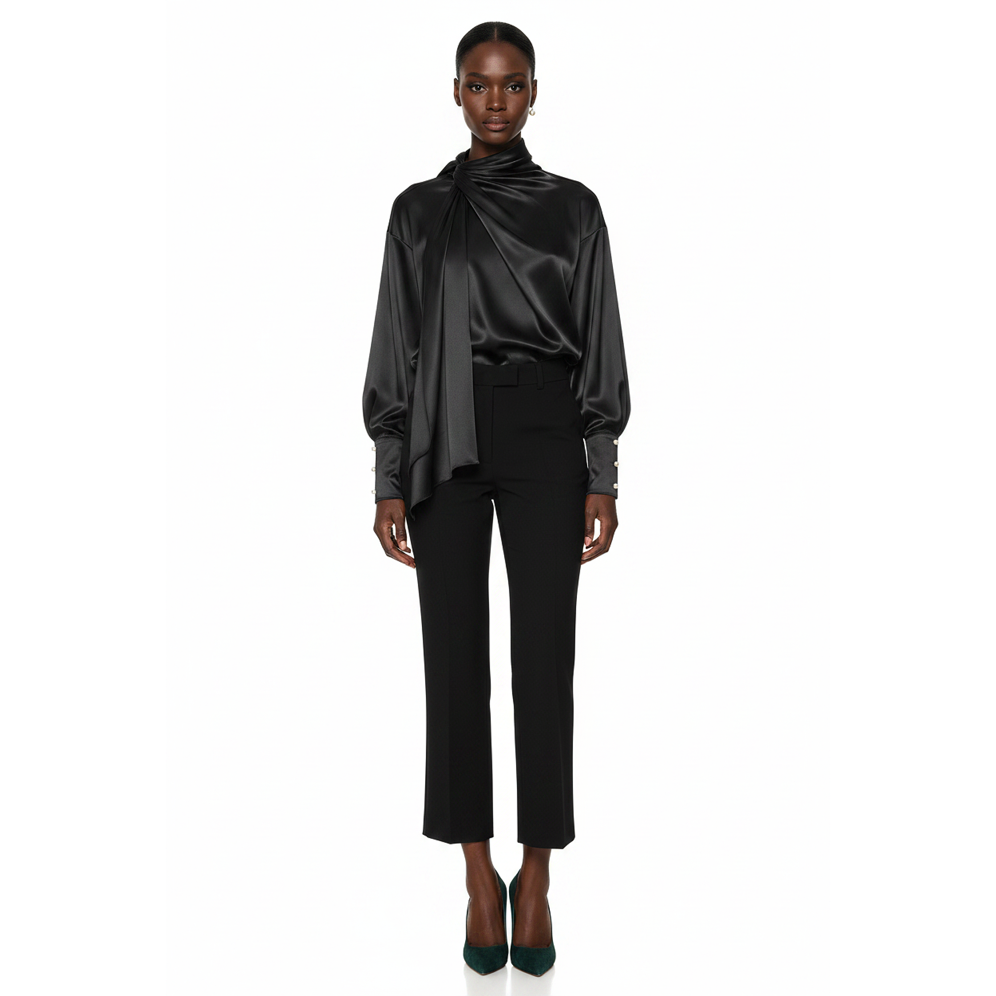 Woman wearing a black satin blouse and pants on a white background