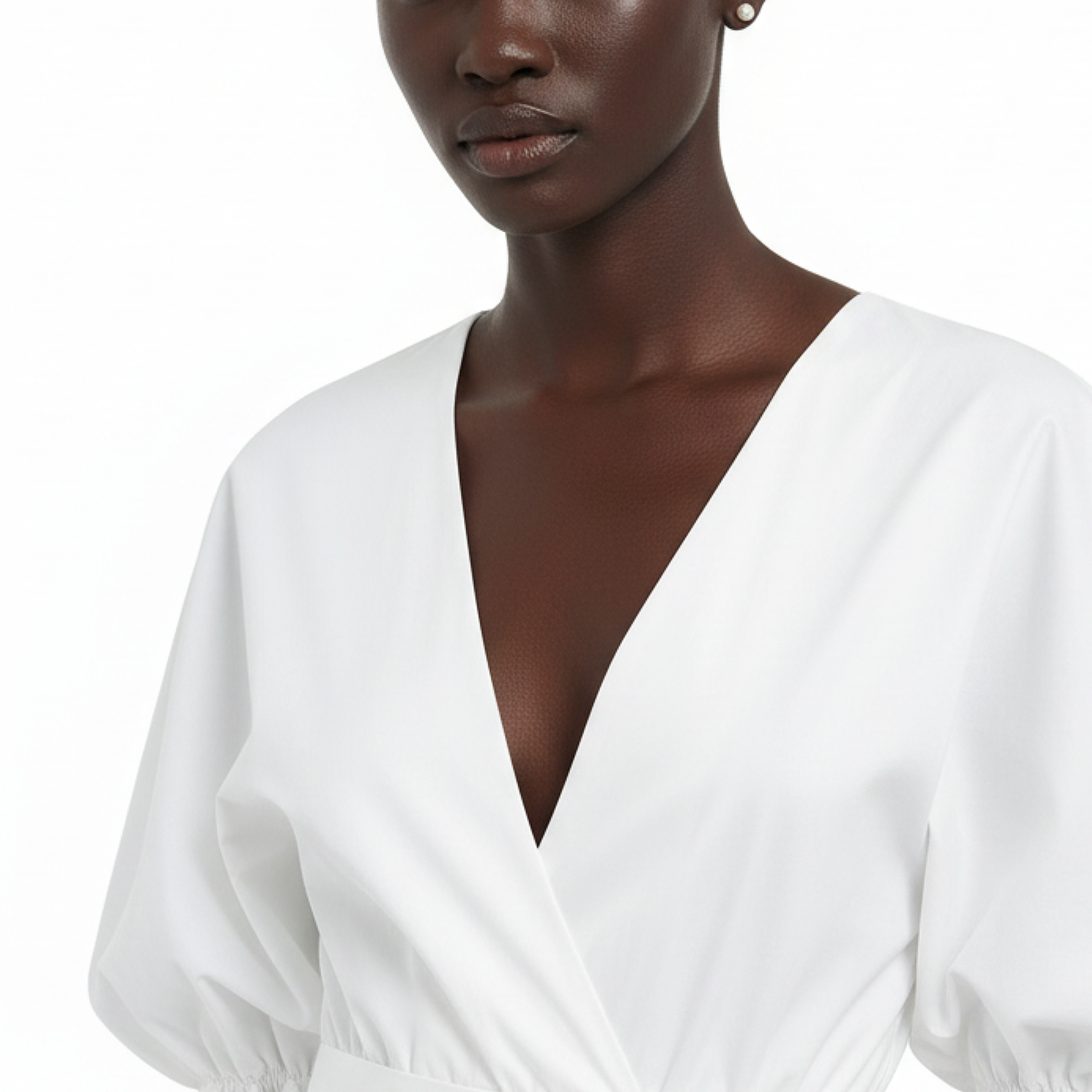 White blouse worn by a model on a white background