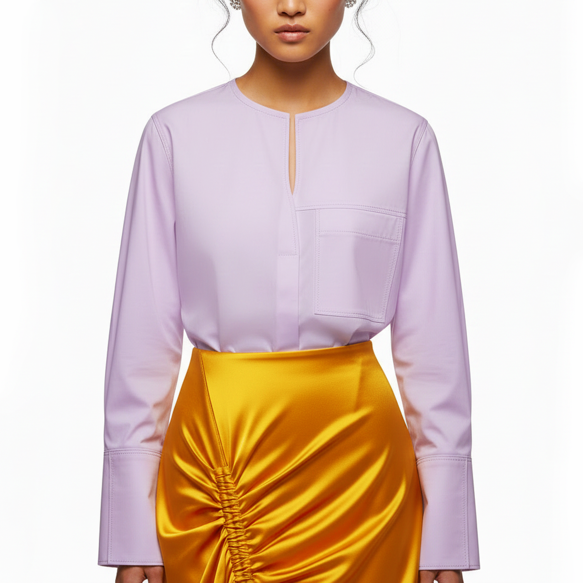 Person wearing a light purple top and yellow skirt on a white background