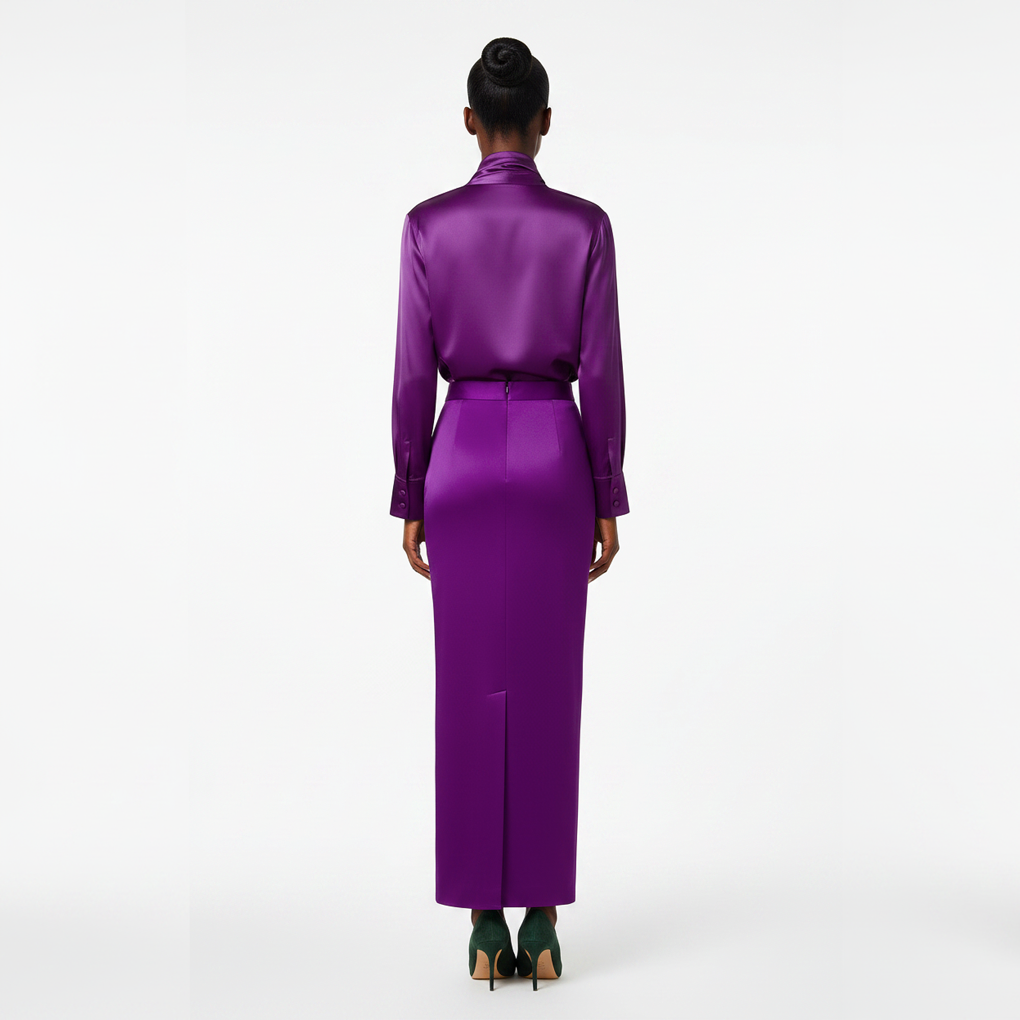 Person wearing a long purple dress on a white background