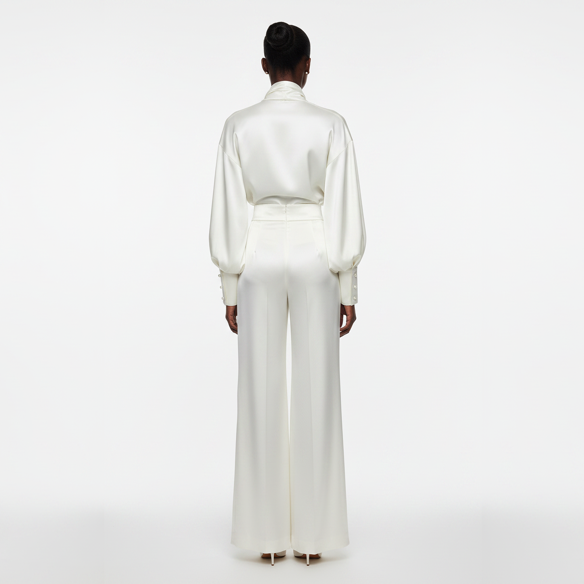 Person wearing a white outfit on a white background
