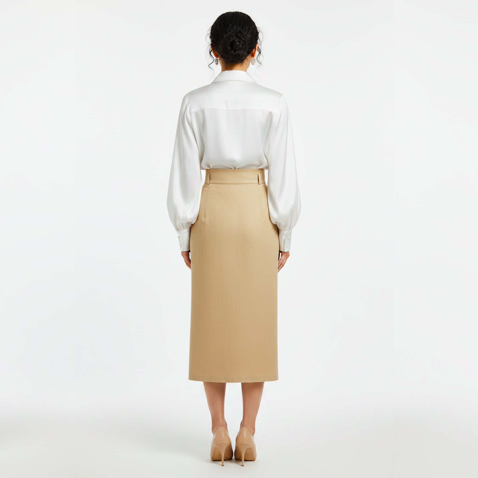 Person wearing a white blouse and beige skirt on a white background