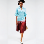 Woman wearing a light blue top and red skirt on a white background