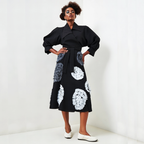 Woman wearing a black Skirt with floral patterns on a white background