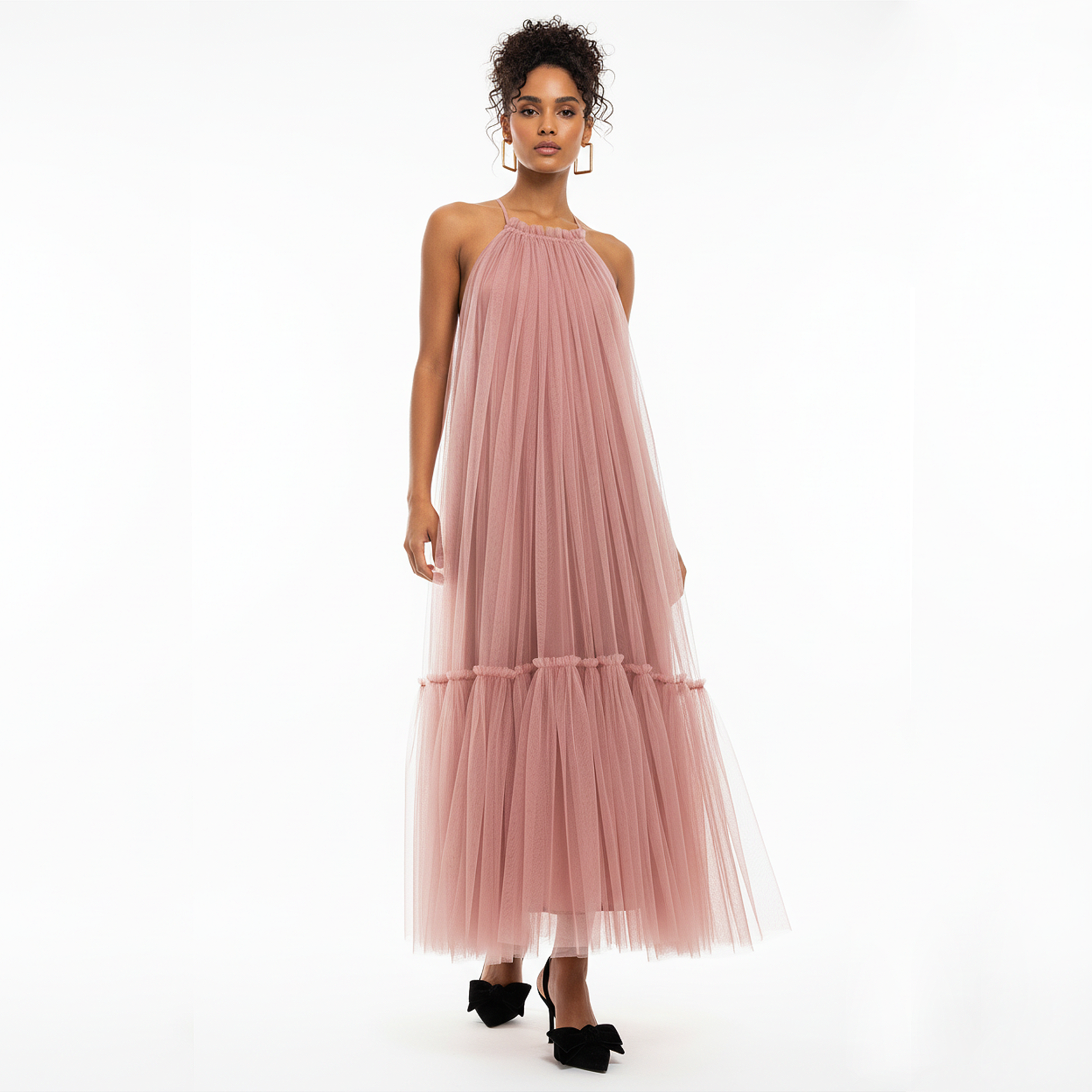 Woman wearing a pink tulle dress on a white background