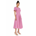 Woman wearing a pink dress with silver embellishments on a white background