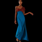 Woman wearing a two-tone dress with a red top and blue skirt on a black background