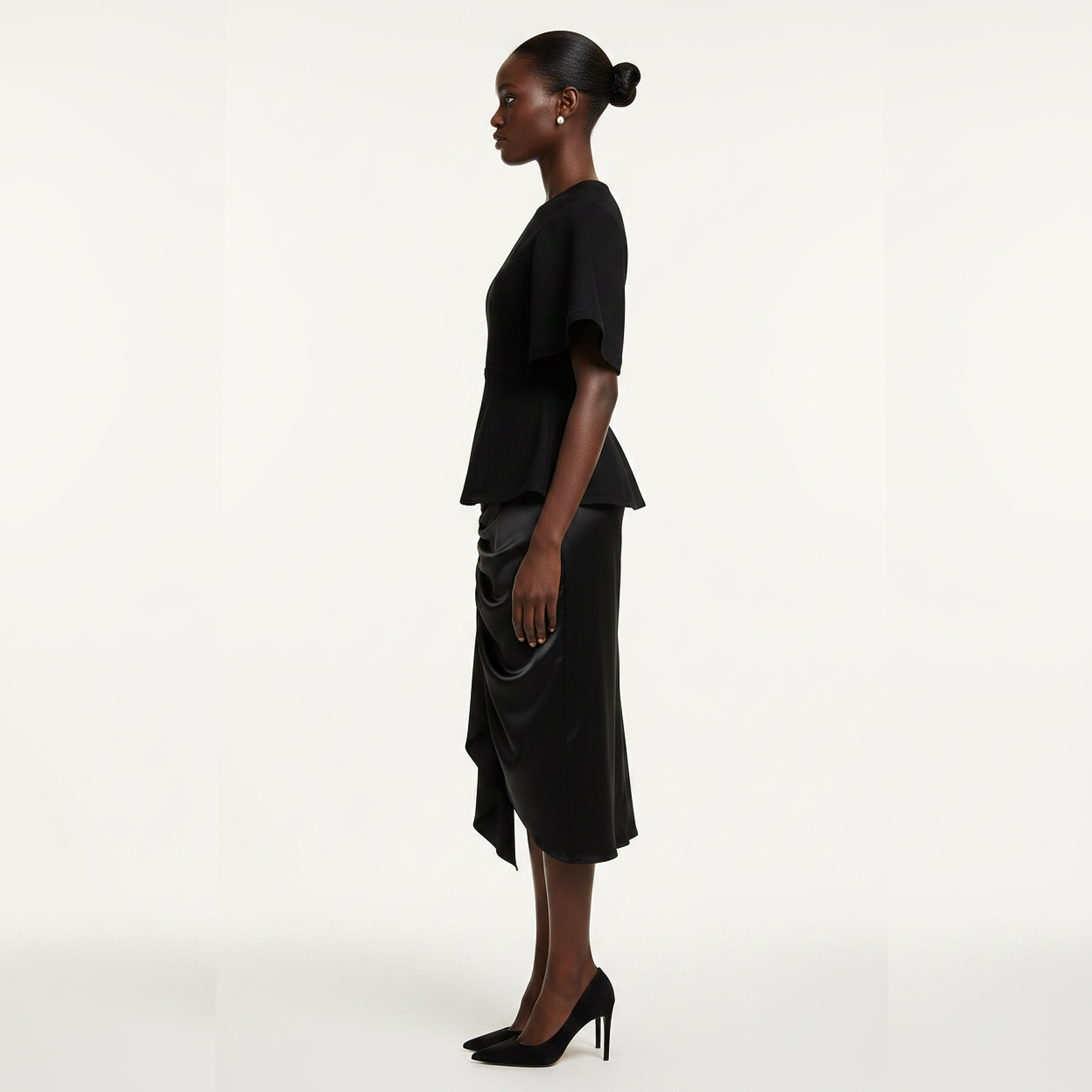 Woman wearing a black outfit on a white background
