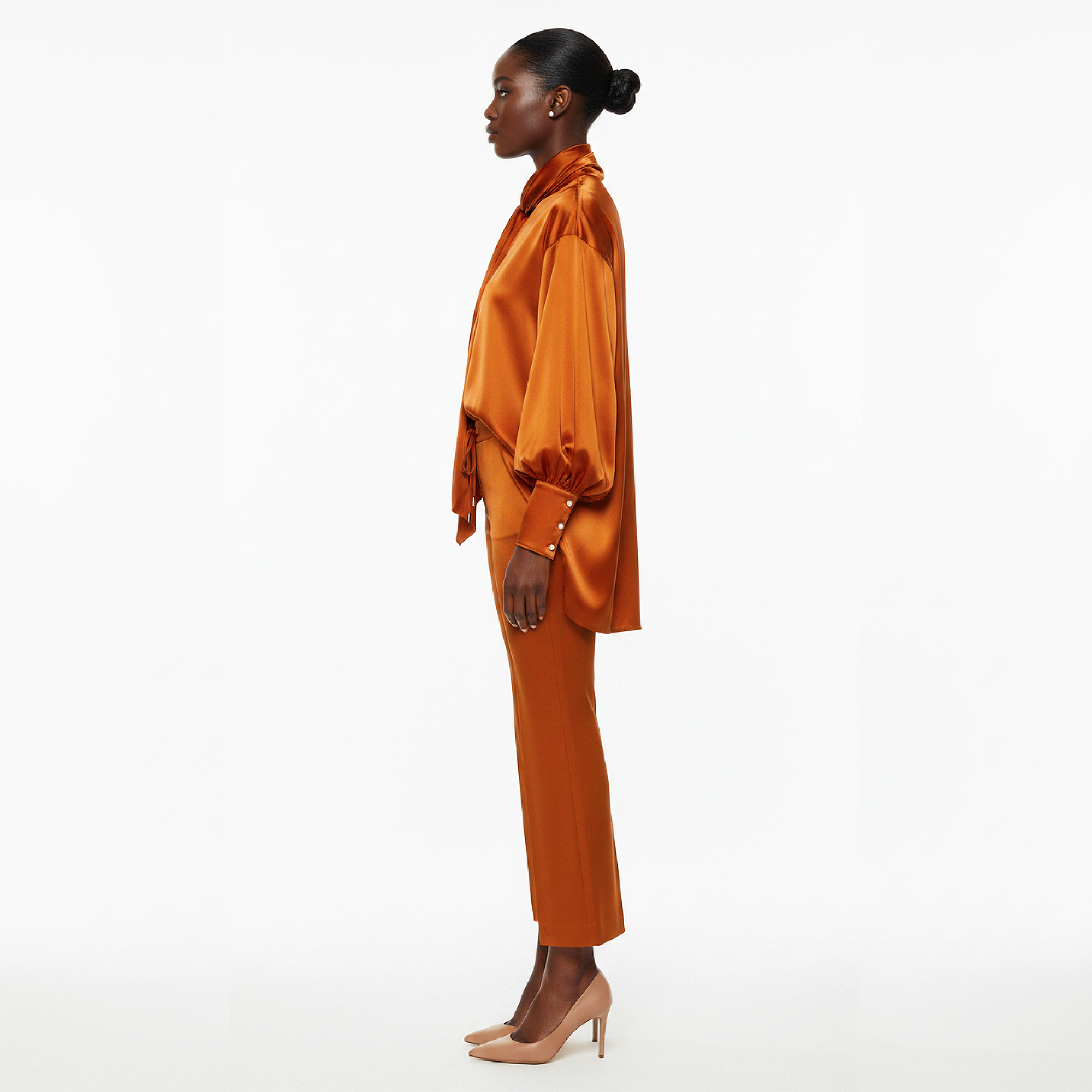 Woman wearing an orange satin outfit on a white background