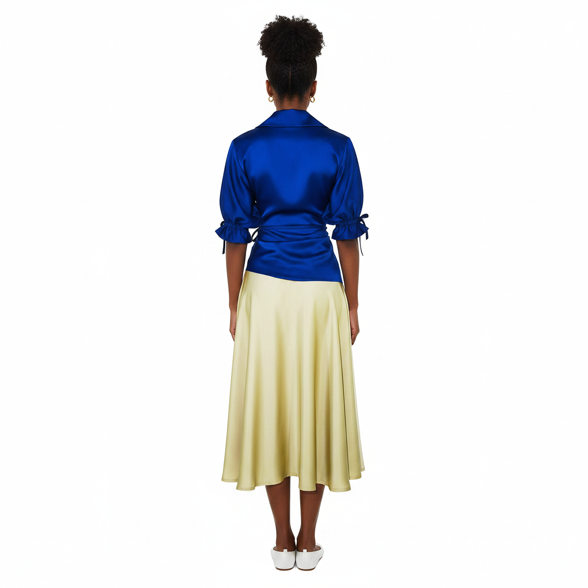Woman wearing a dress with a  blue satin top and yellow skirt on a white background