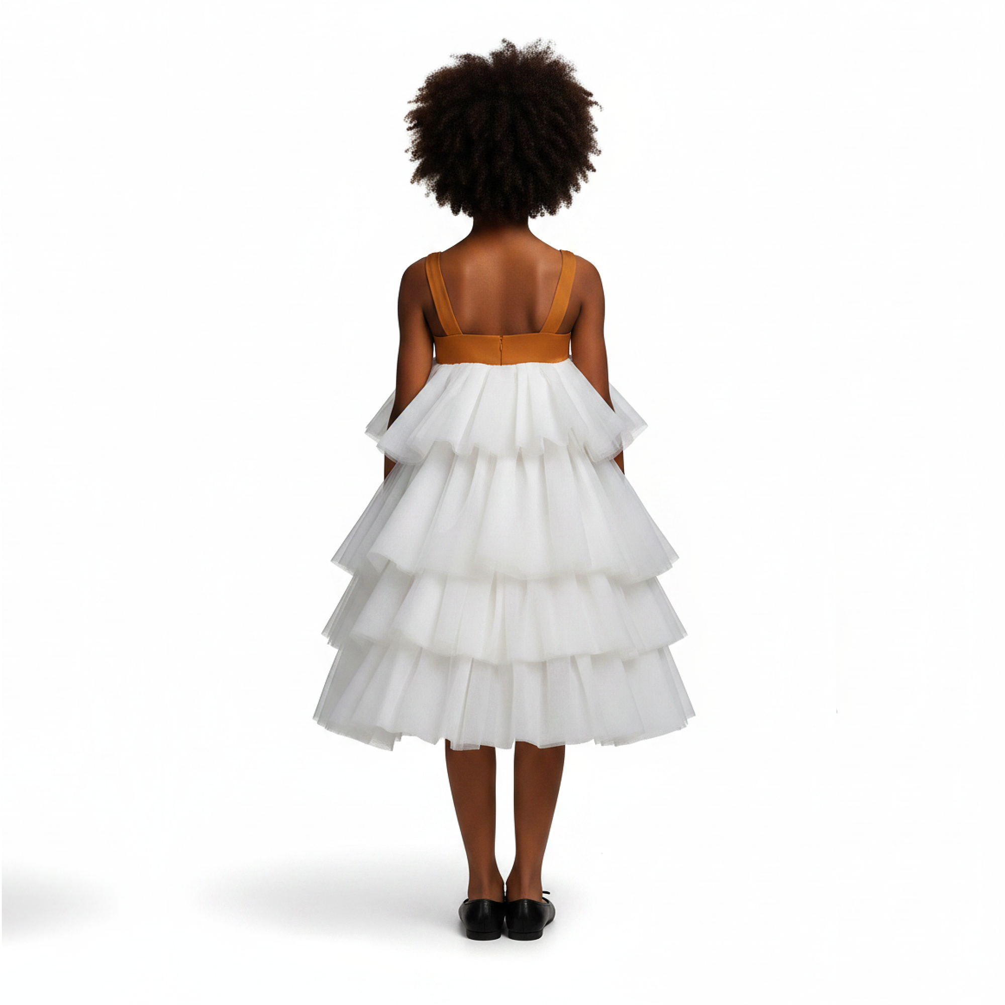 Young girl wearing a white tiered dress with a brown top on a black background