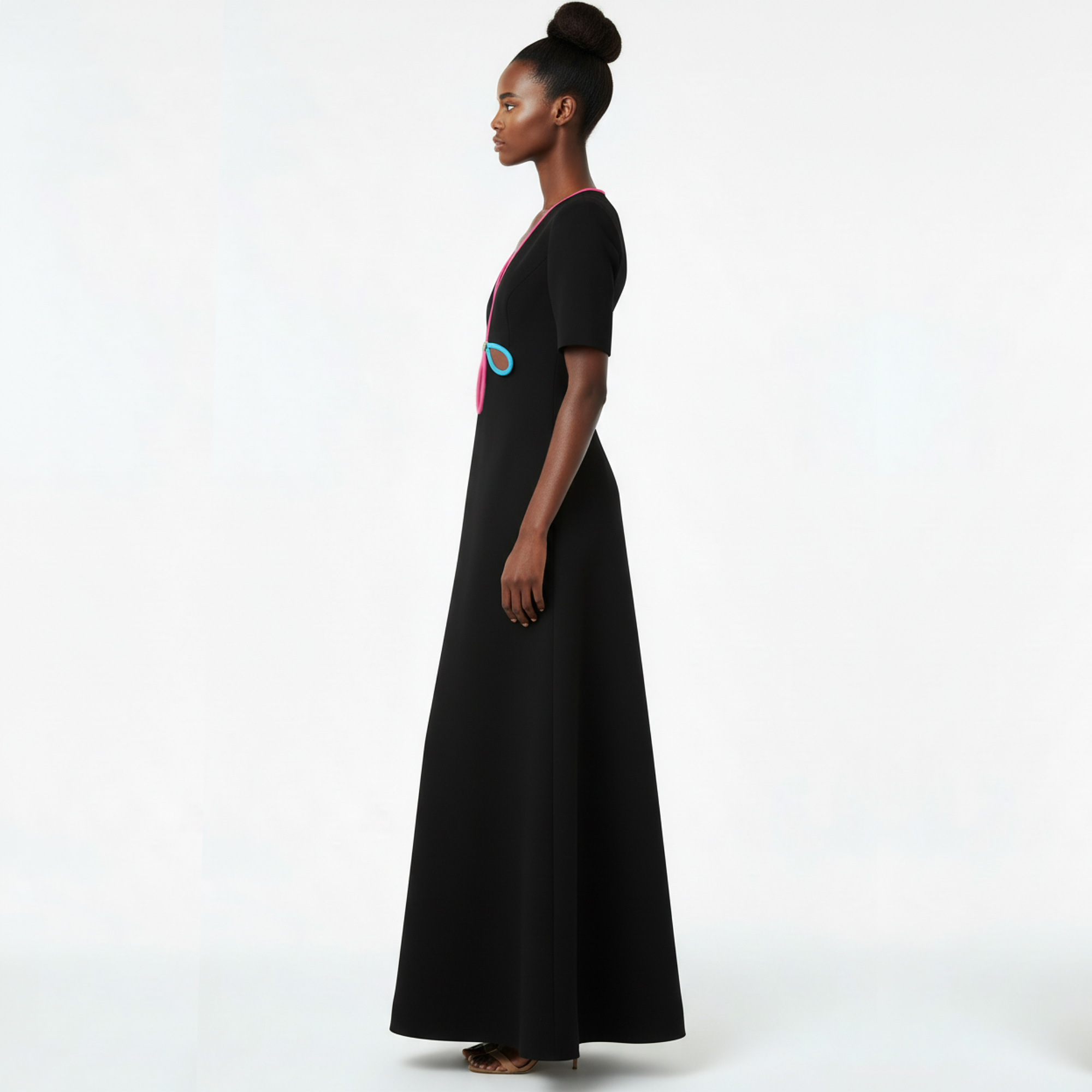 Woman wearing a black dress with colorful accents on a white background