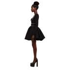 Woman wearing a black dress with a white background