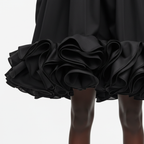Black ruffled skirt on a white background