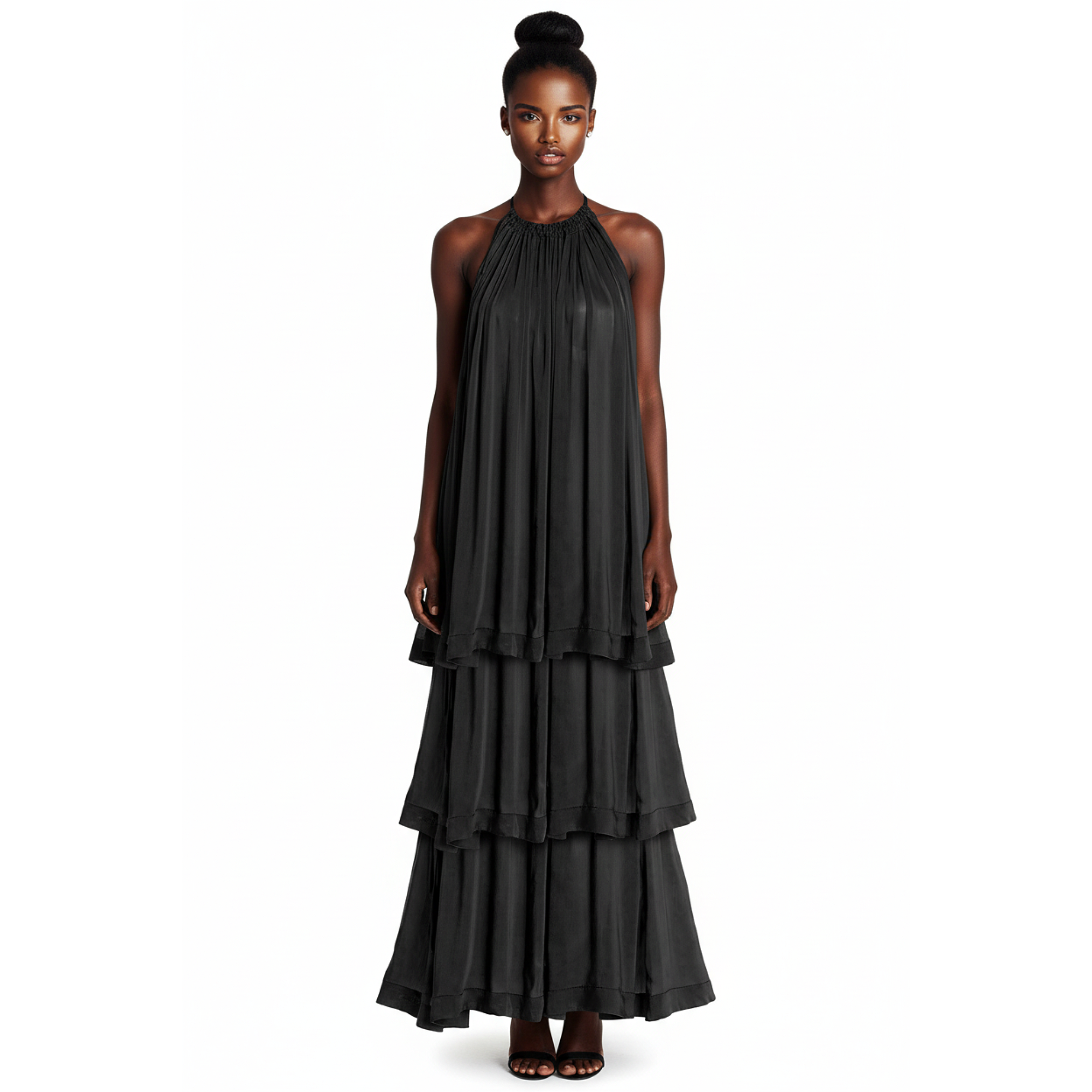 Woman wearing a black tiered dress on a white background