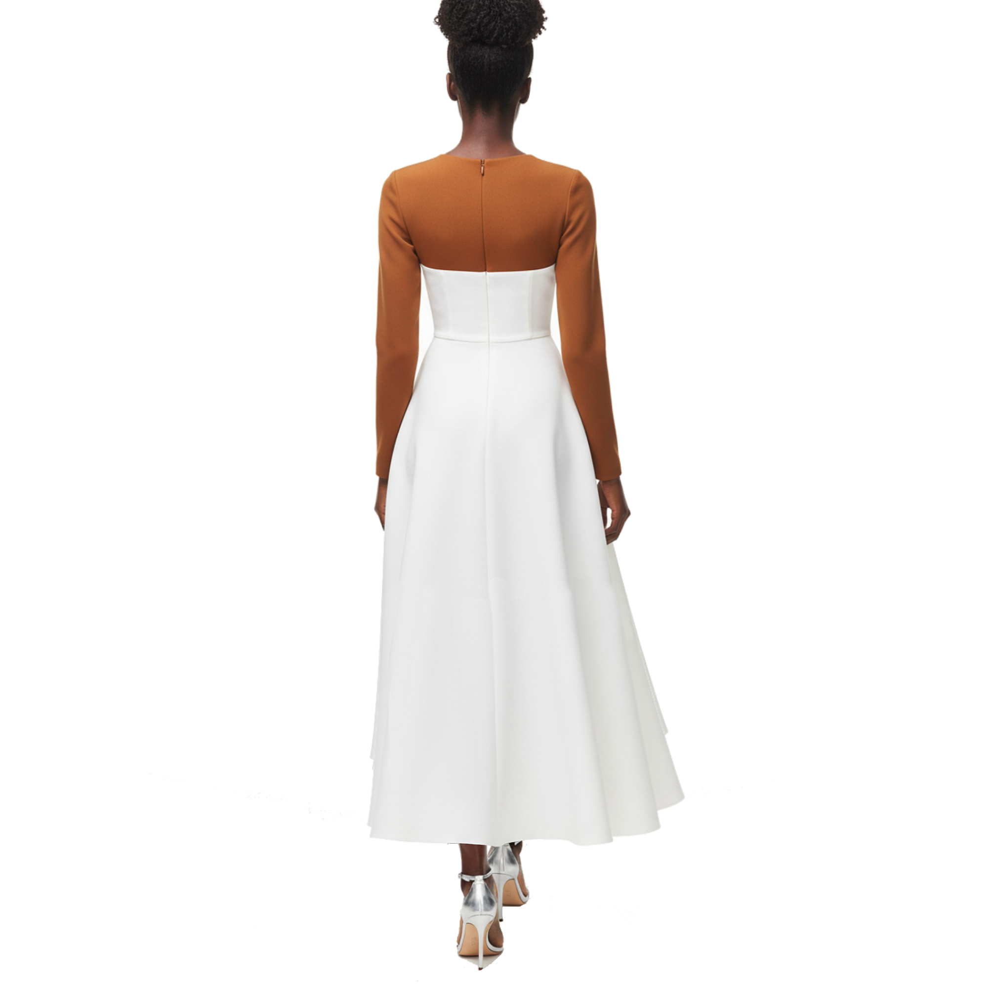 Woman wearing a white dress with a brown long-sleeve top on a white background
