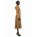 Woman wearing a long beige coat on a white background