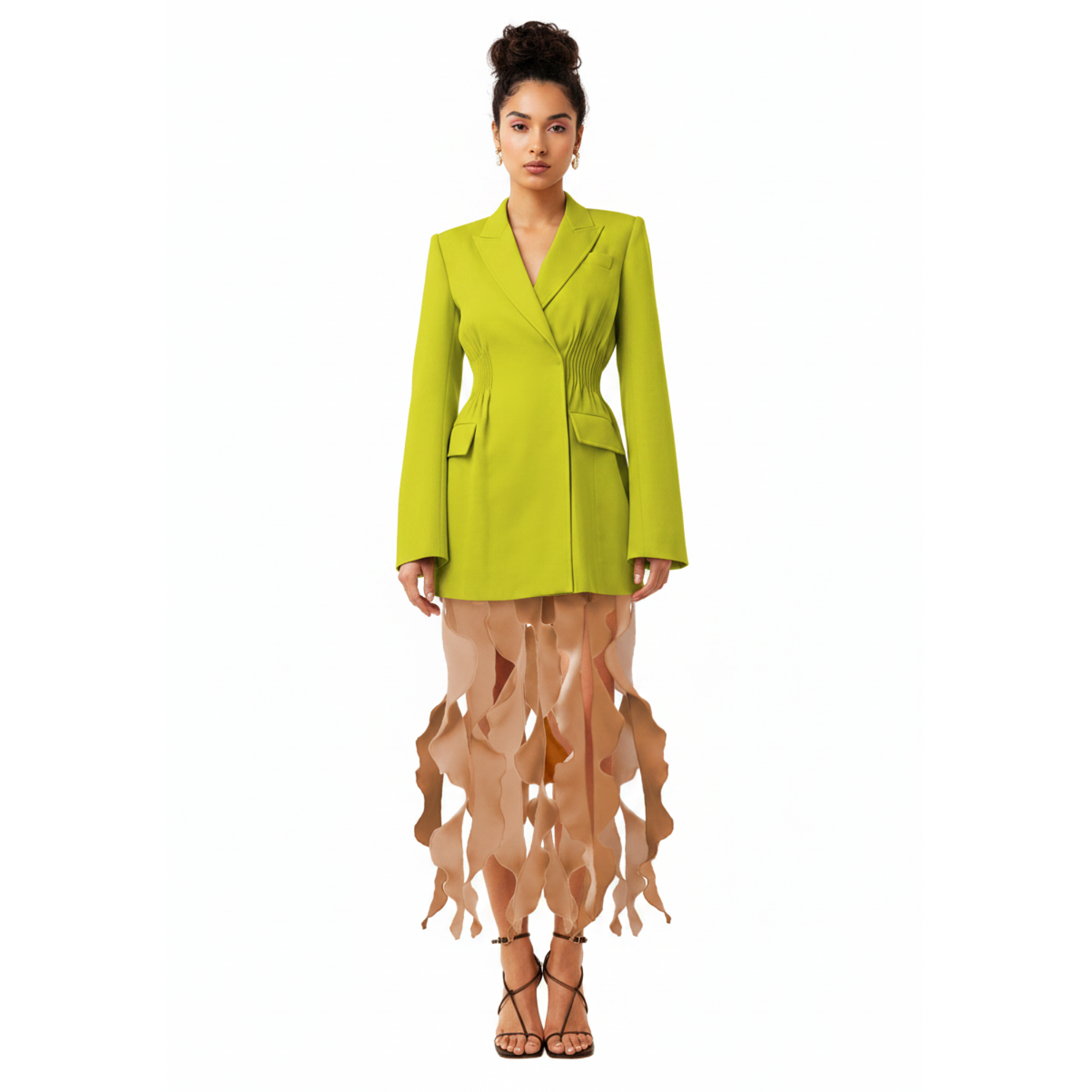 Woman wearing a bright green blazer over a sheer dress on a white background
