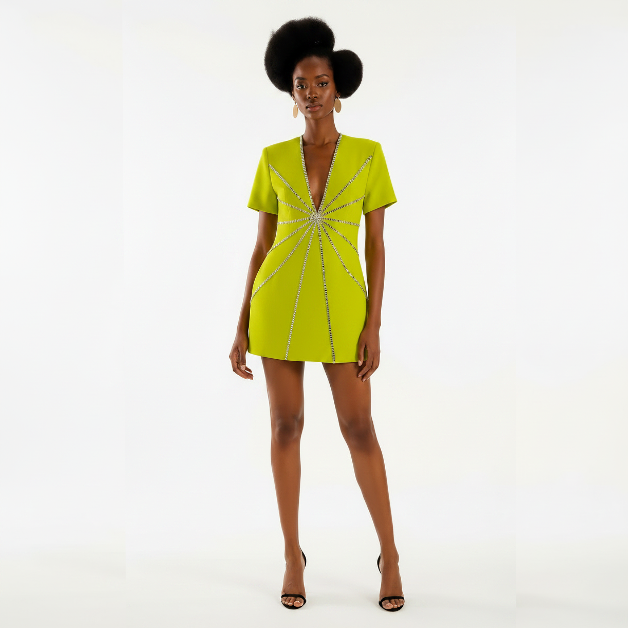 Woman wearing a bright green dress with a starburst pattern on a white background