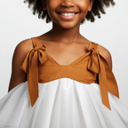 White tiered dress worn by a person on a black background