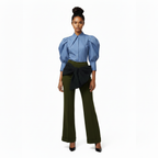 Woman wearing a blue blouse with puffed sleeves and green pants on a white background
