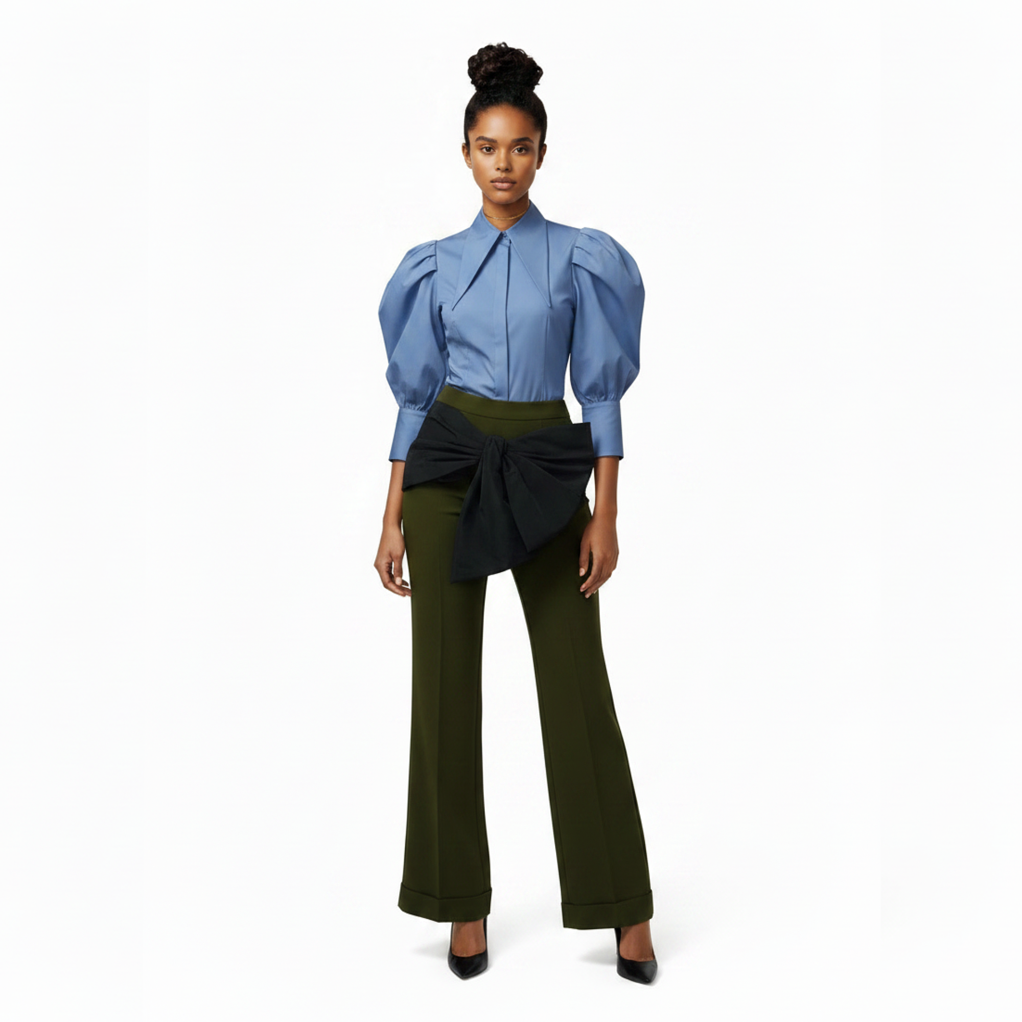 Woman wearing a blue blouse with puffed sleeves and green pants on a white background