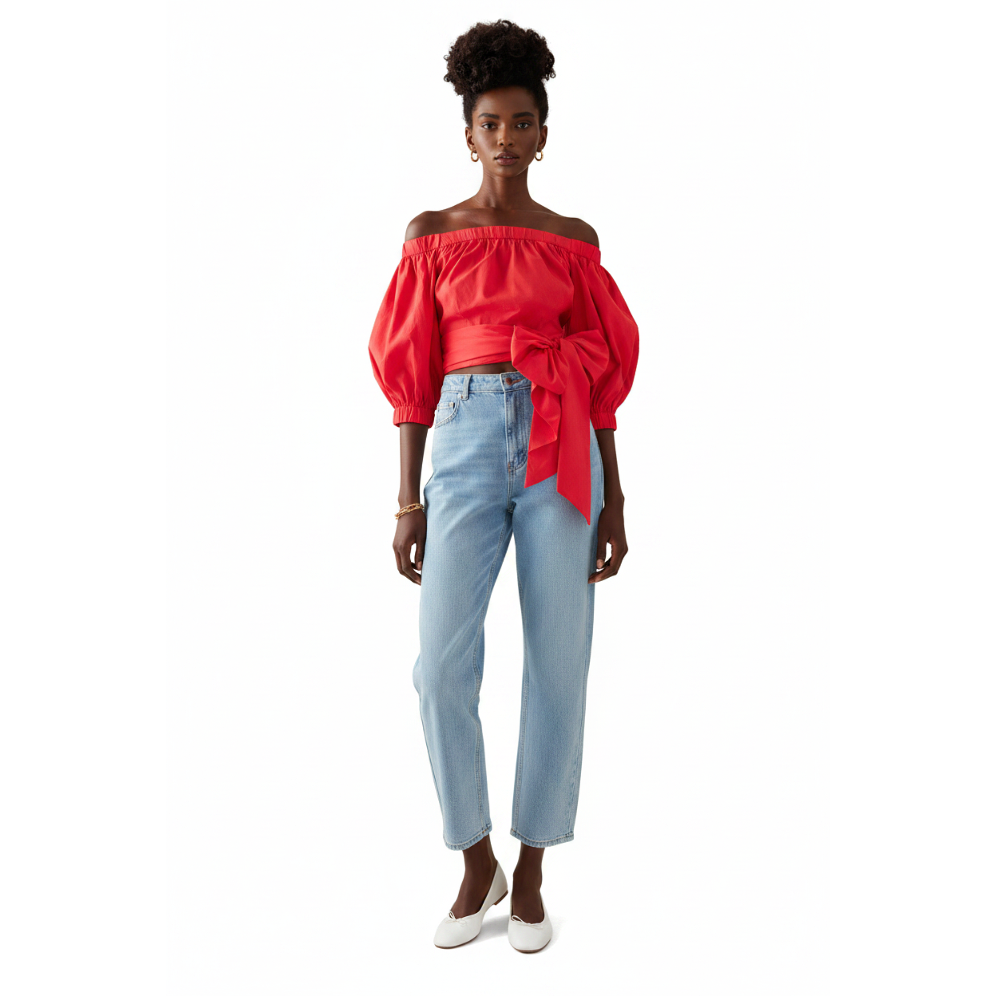 Woman wearing a red off-shoulder top with a blue jeans on a white background