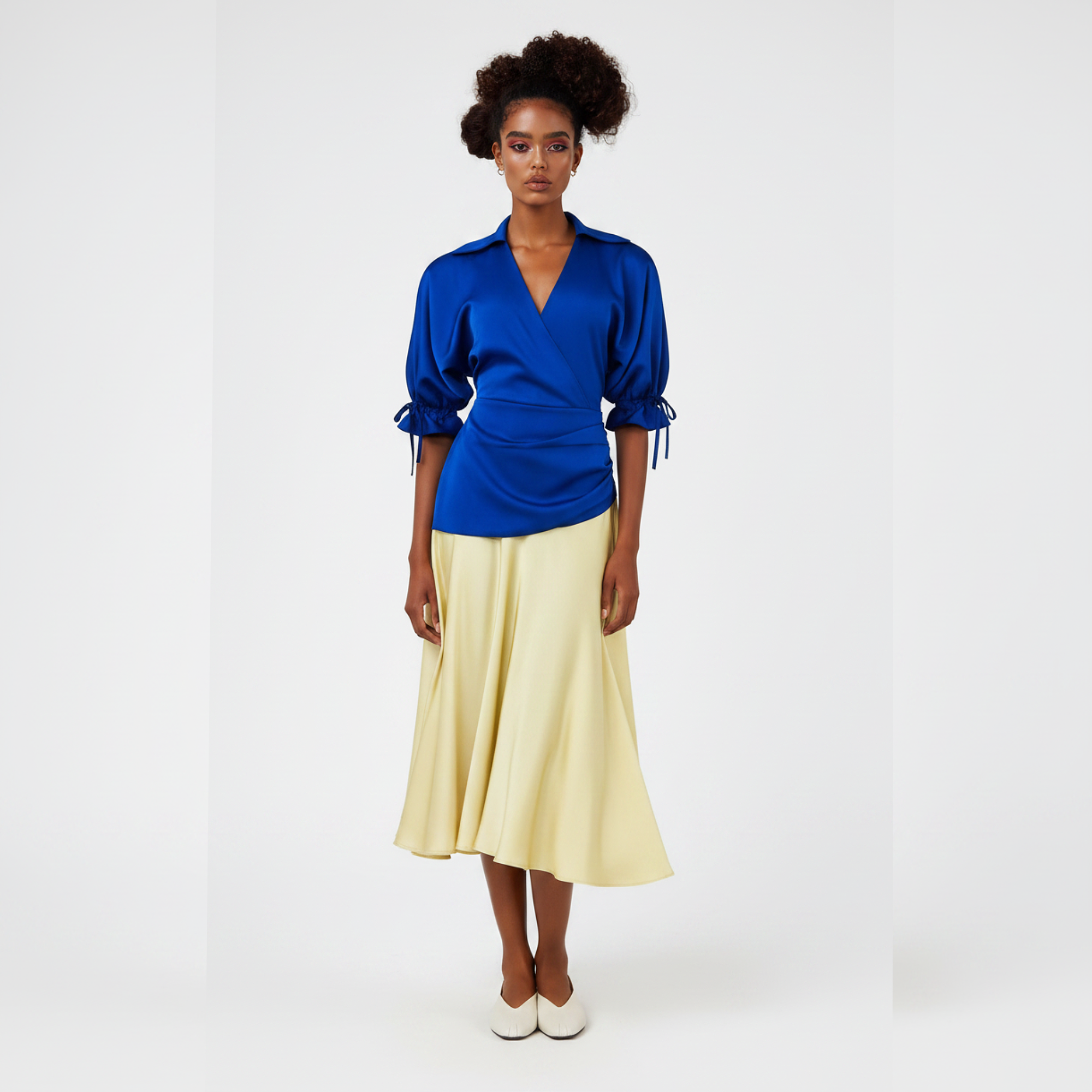 Woman wearing a dress with a  blue top and yellow skirt on a white background
