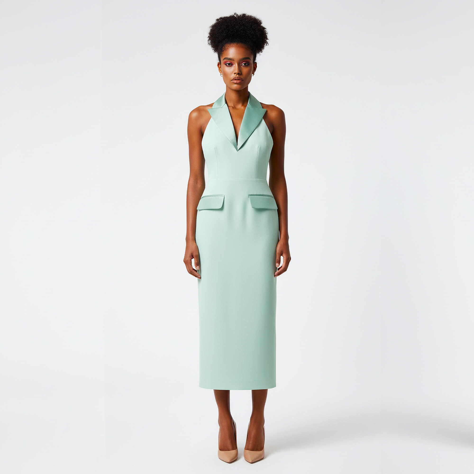 Woman wearing a light green dress against a white background