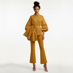 Woman wearing a mustard yellow outfit on a white background