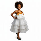 White tiered dress worn by a person on a black background