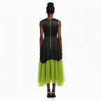 Woman wearing a black and green dress on a white background