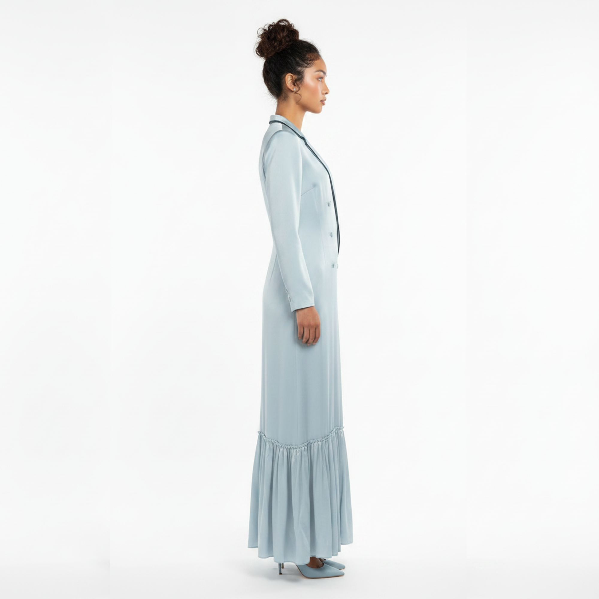 Woman wearing a light blue dress with a white background