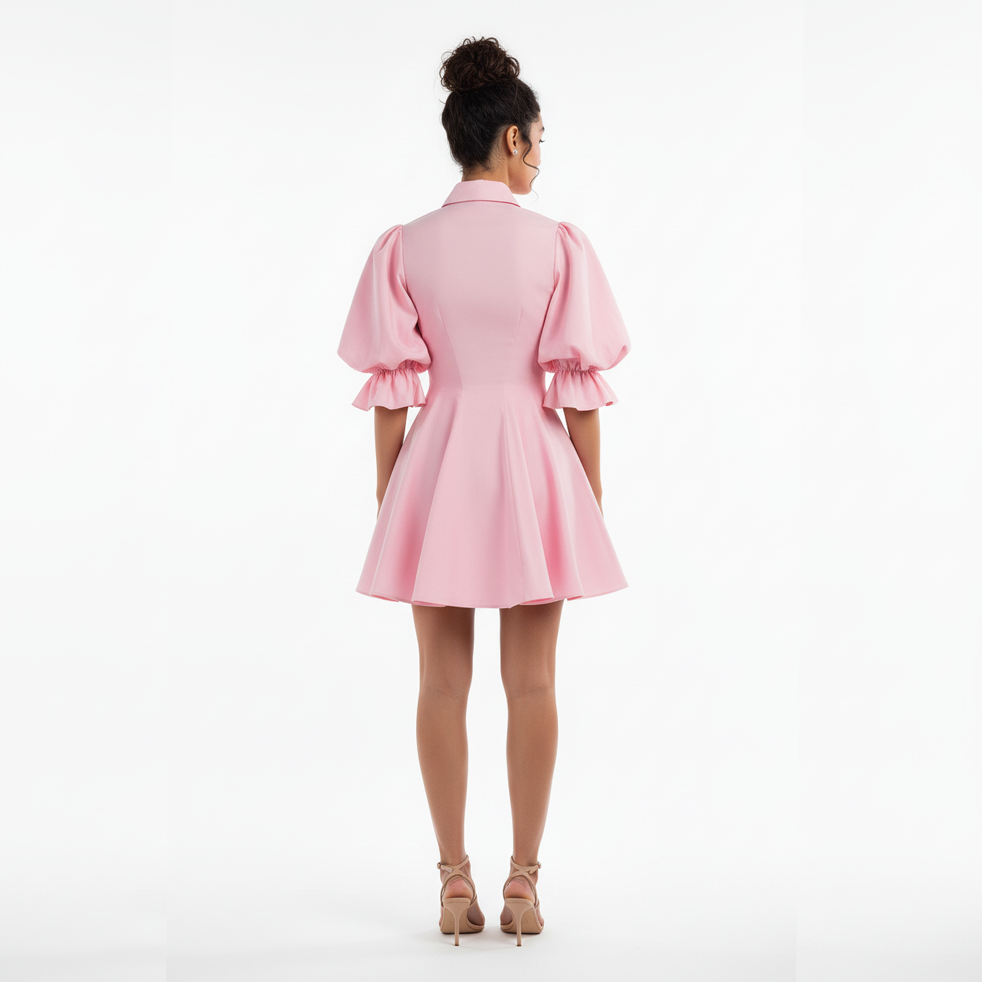 Woman wearing a pink dress on a white background