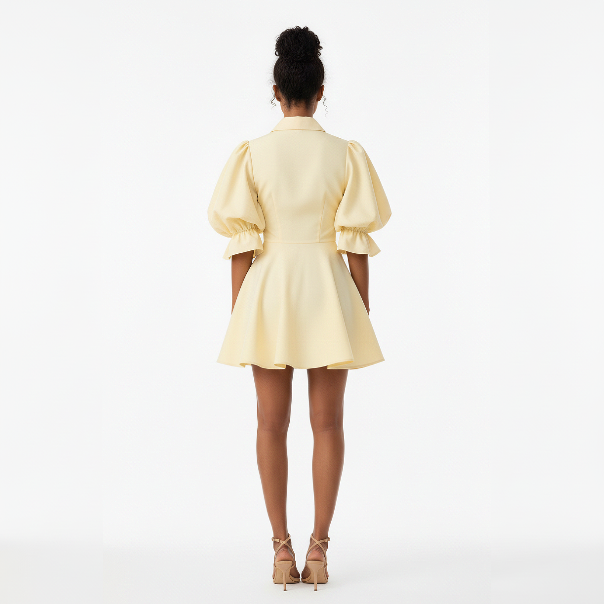 Person wearing a light yellow dress on a white background