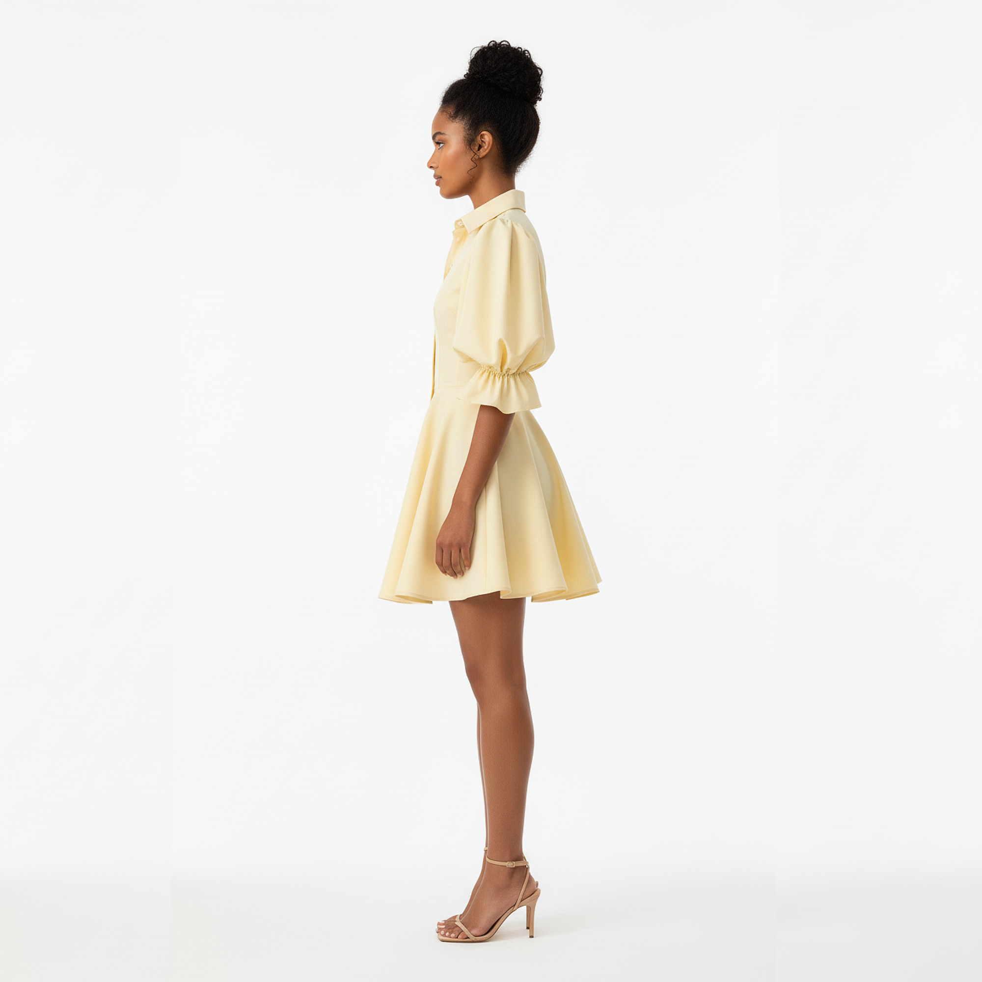 Woman wearing a light yellow dress on a white background