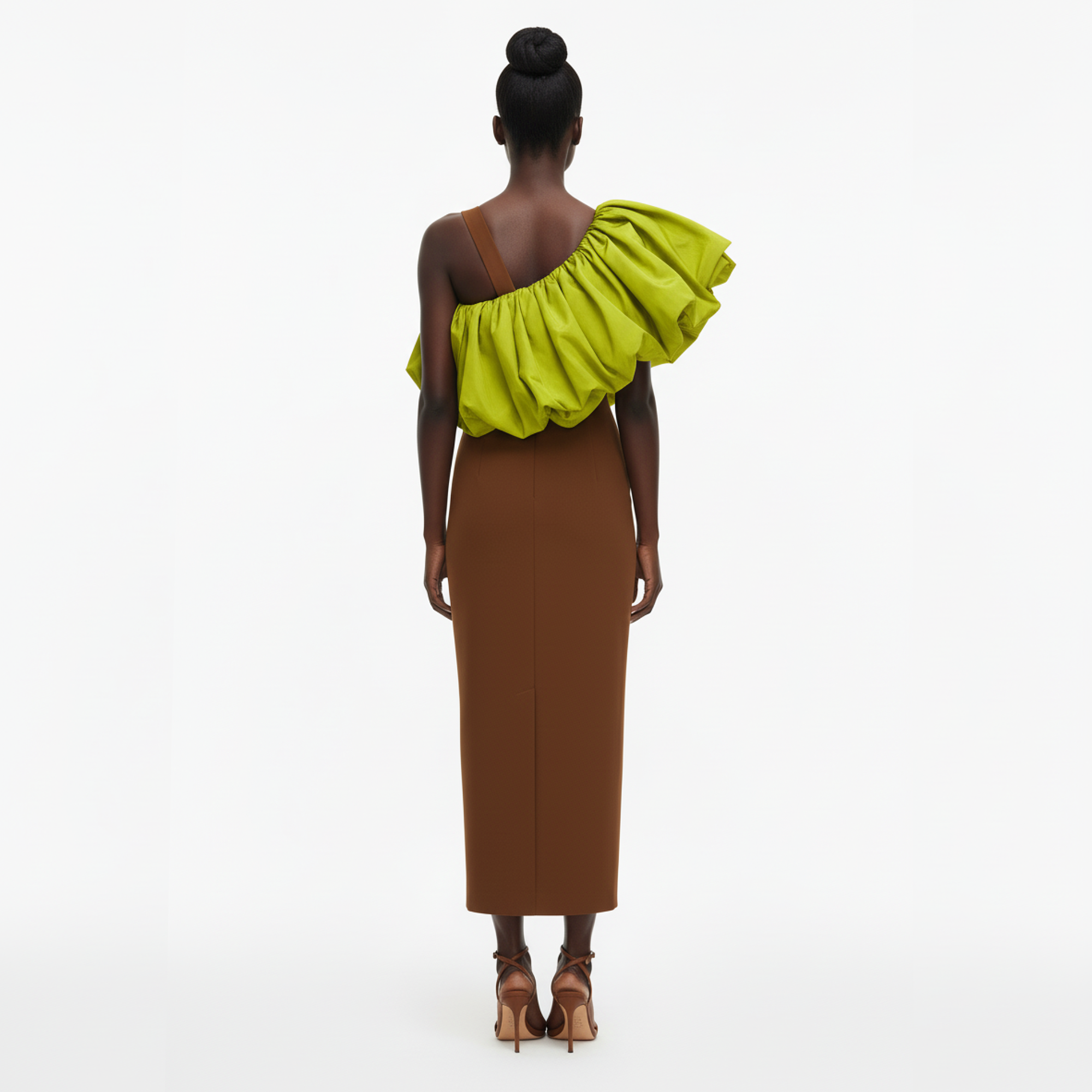 Woman wearing a brown and green dress with ruffled shoulder on a white background