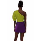 Person wearing a green and purple dress on a white background