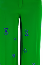 Green pants with blue geometric patterns on a white background