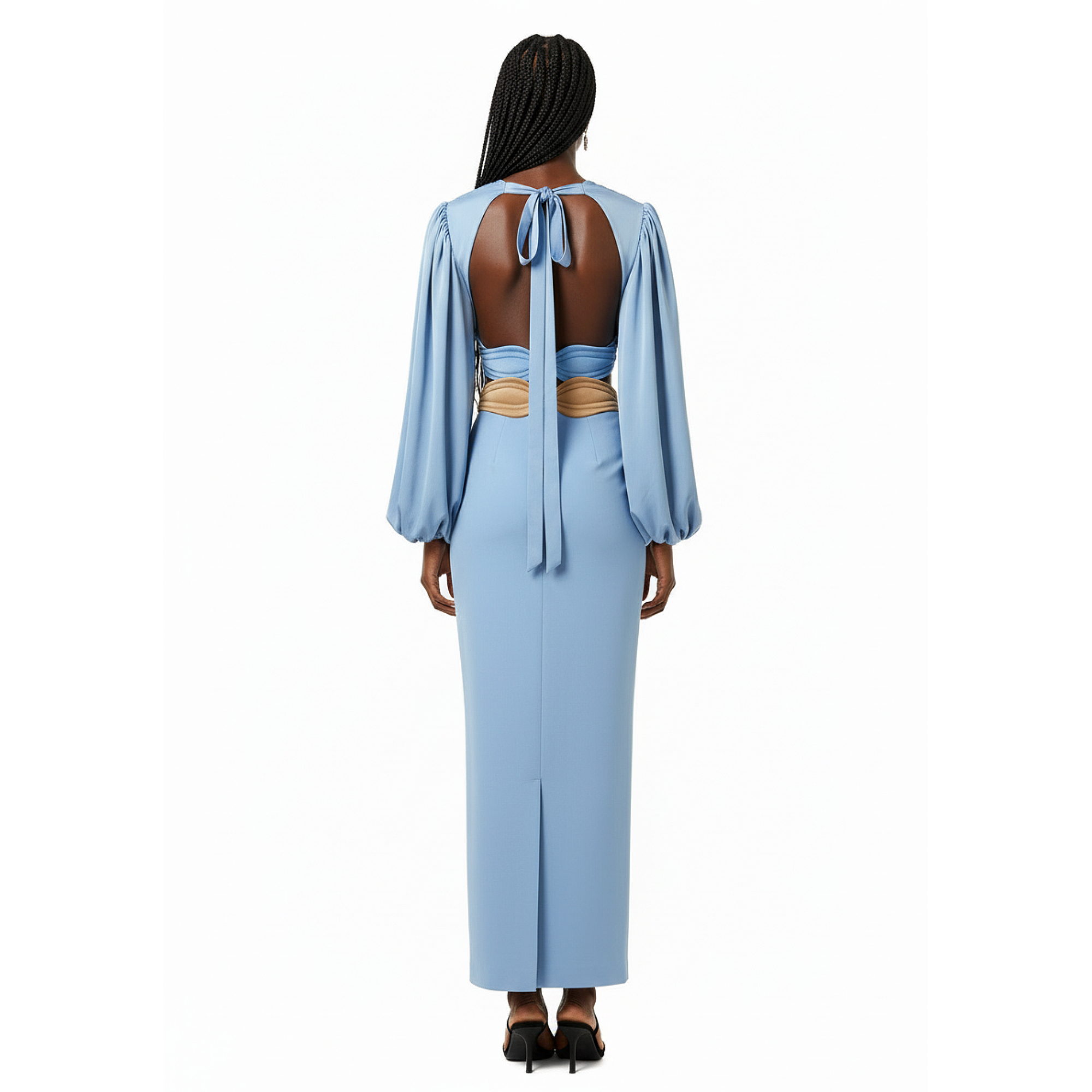 Woman wearing a light blue dress with open back on a white background