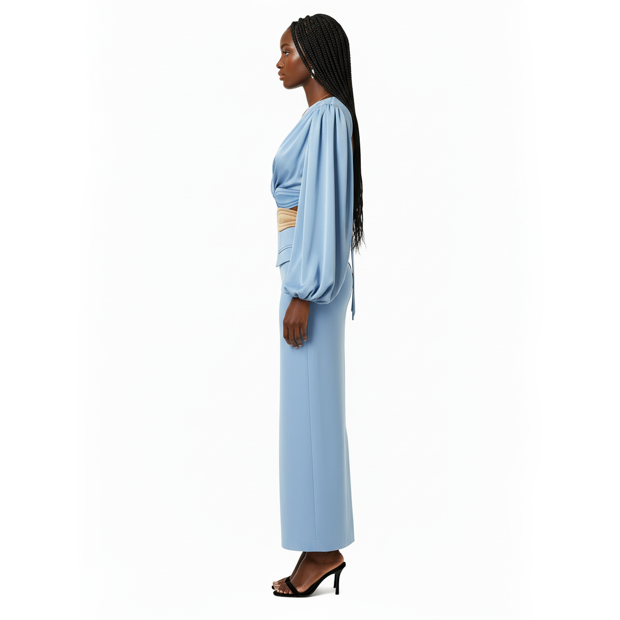 Woman wearing a light blue dress with a white background