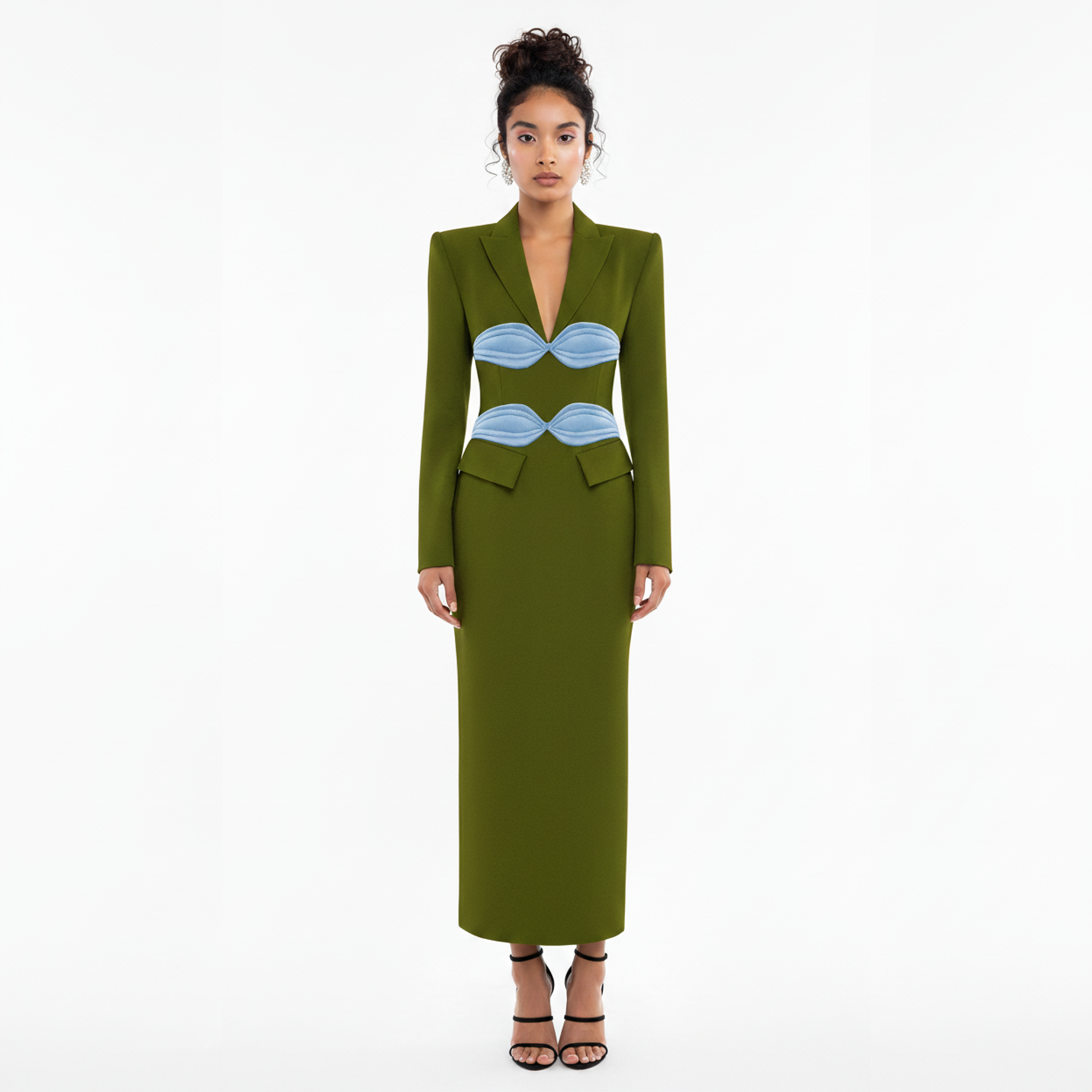 Woman wearing a green dress with blue accents on a white background