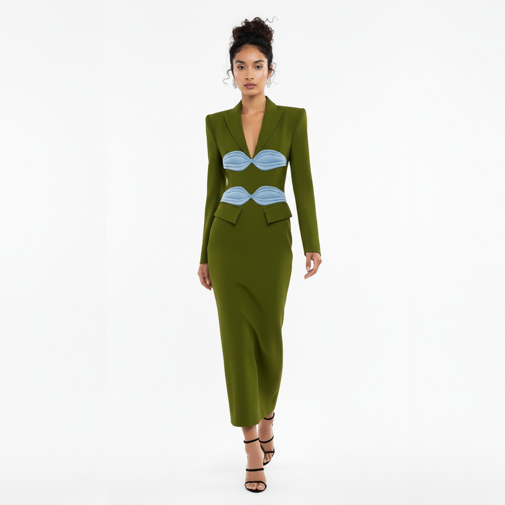 Woman wearing a green dress with blue accents on a white background